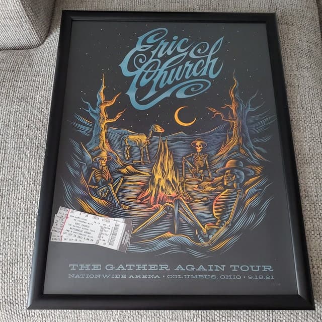 A framed Eric Church poster with Stubforge tickets